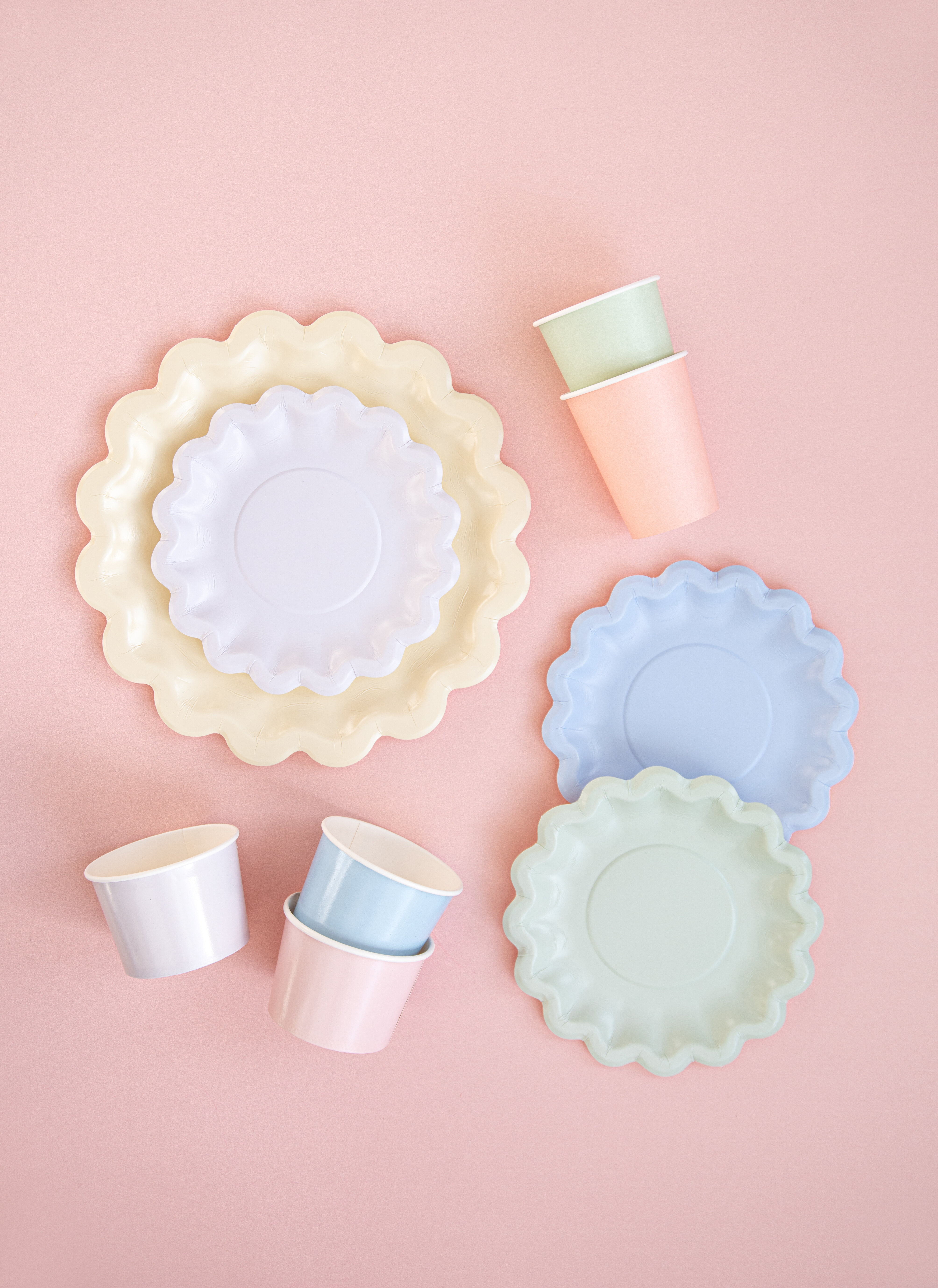 Blomformade engångsartiklar mot rosa bakgrund.